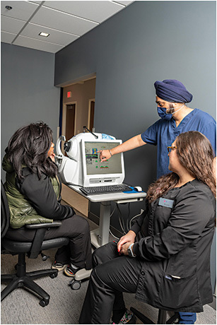 Dr. Singh explains the results of OCT testing (Cirrus HD-OCT, Zeiss), assisted by Ms. Cacciato (right).