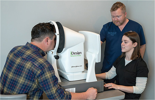Tighe Richardson, DO, and Olivia Beland, COA, refractive surgery coordinator, perform an iDesign test (J&J Vision) on a patient.