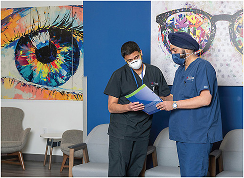 Dr. Singh (right) discusses a case with R. Krishna Sanka, MD.